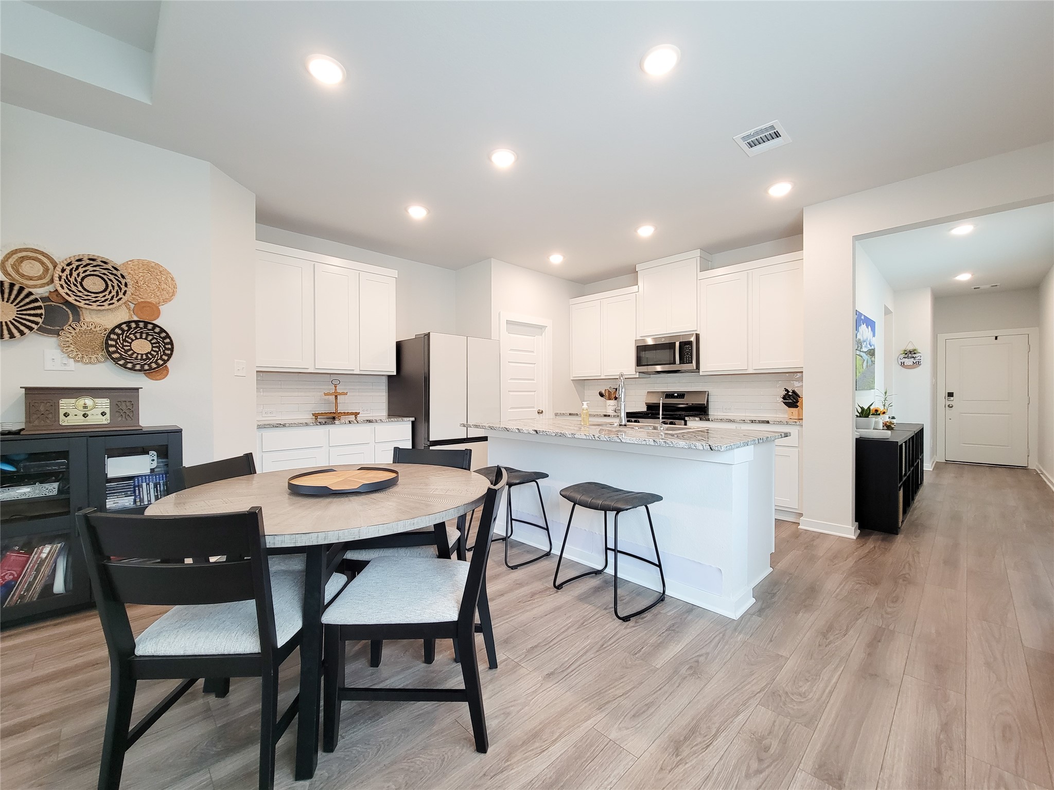 2818 Bluebonnet Ridge Drive Conroe, TX 77304 - Photo 16 of 42 a view of kitchen with cabinets table and chairs