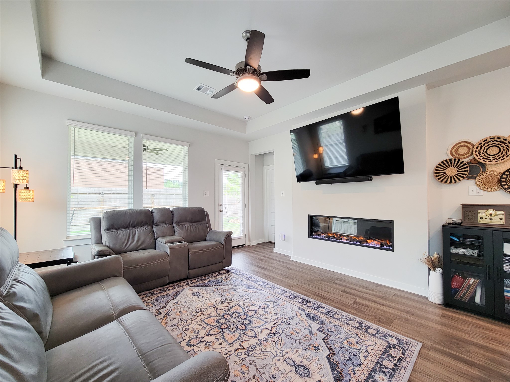 2818 Bluebonnet Ridge Drive Conroe, TX 77304 - Photo 18 of 42 a living room with furniture and a flat screen tv