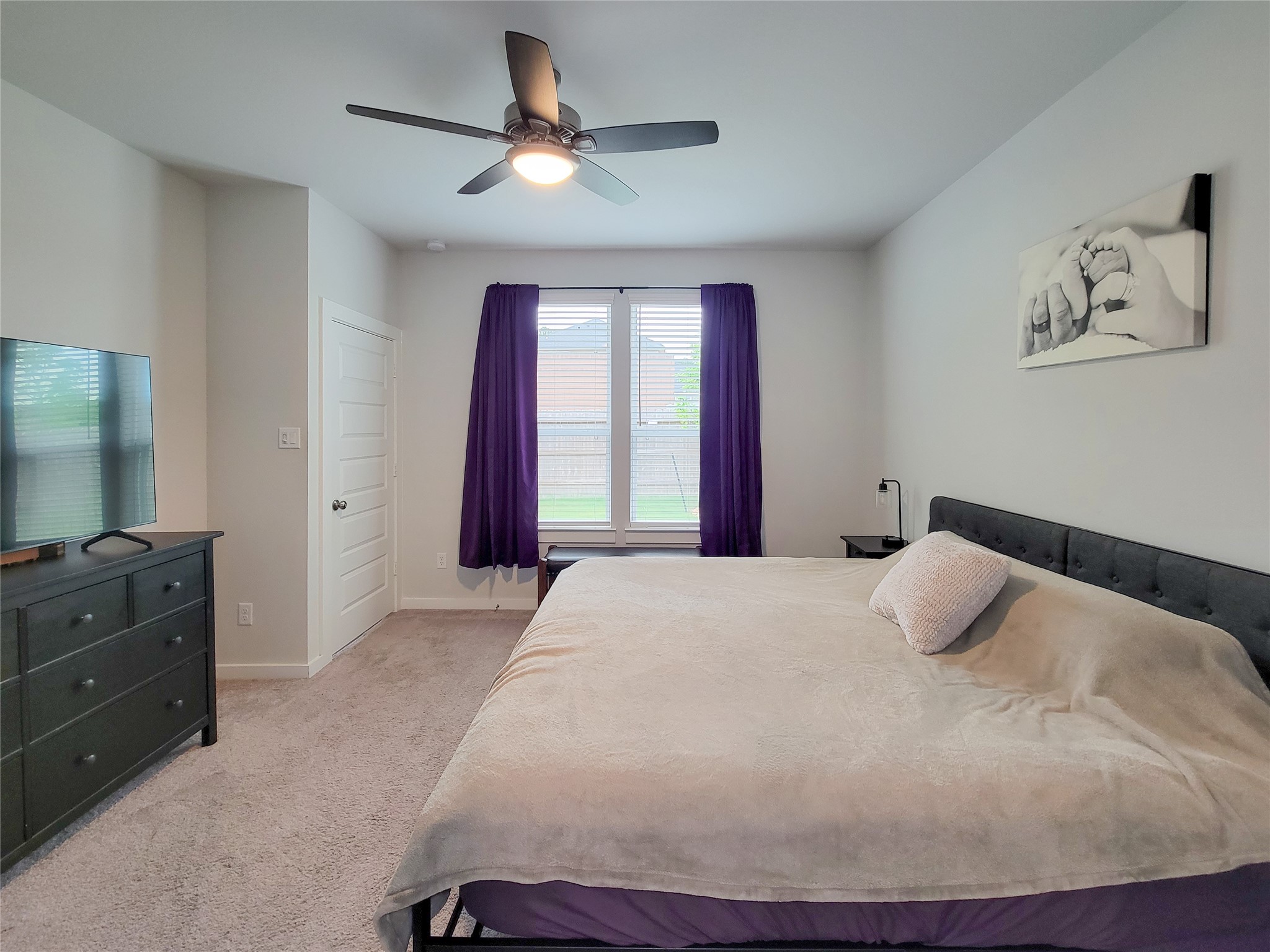 2818 Bluebonnet Ridge Drive Conroe, TX 77304 - Photo 23 of 42 a bedroom with a bed and a chandelier
