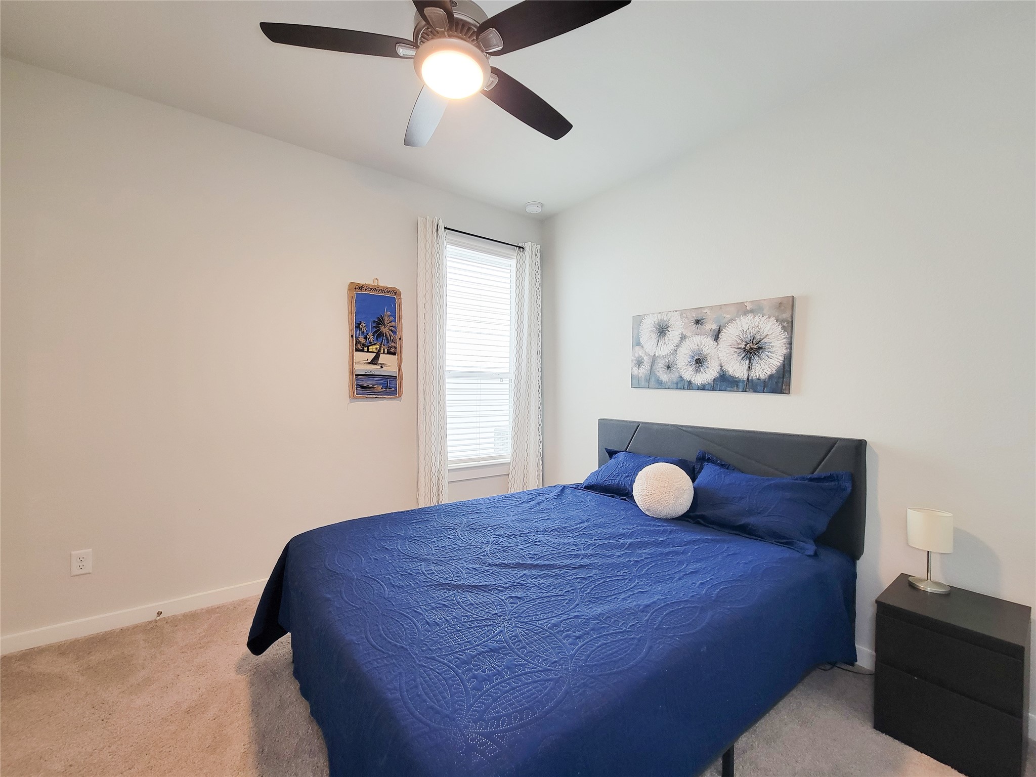 2818 Bluebonnet Ridge Drive Conroe, TX 77304 - Photo 29 of 42 a bedroom with a bed and a chandelier