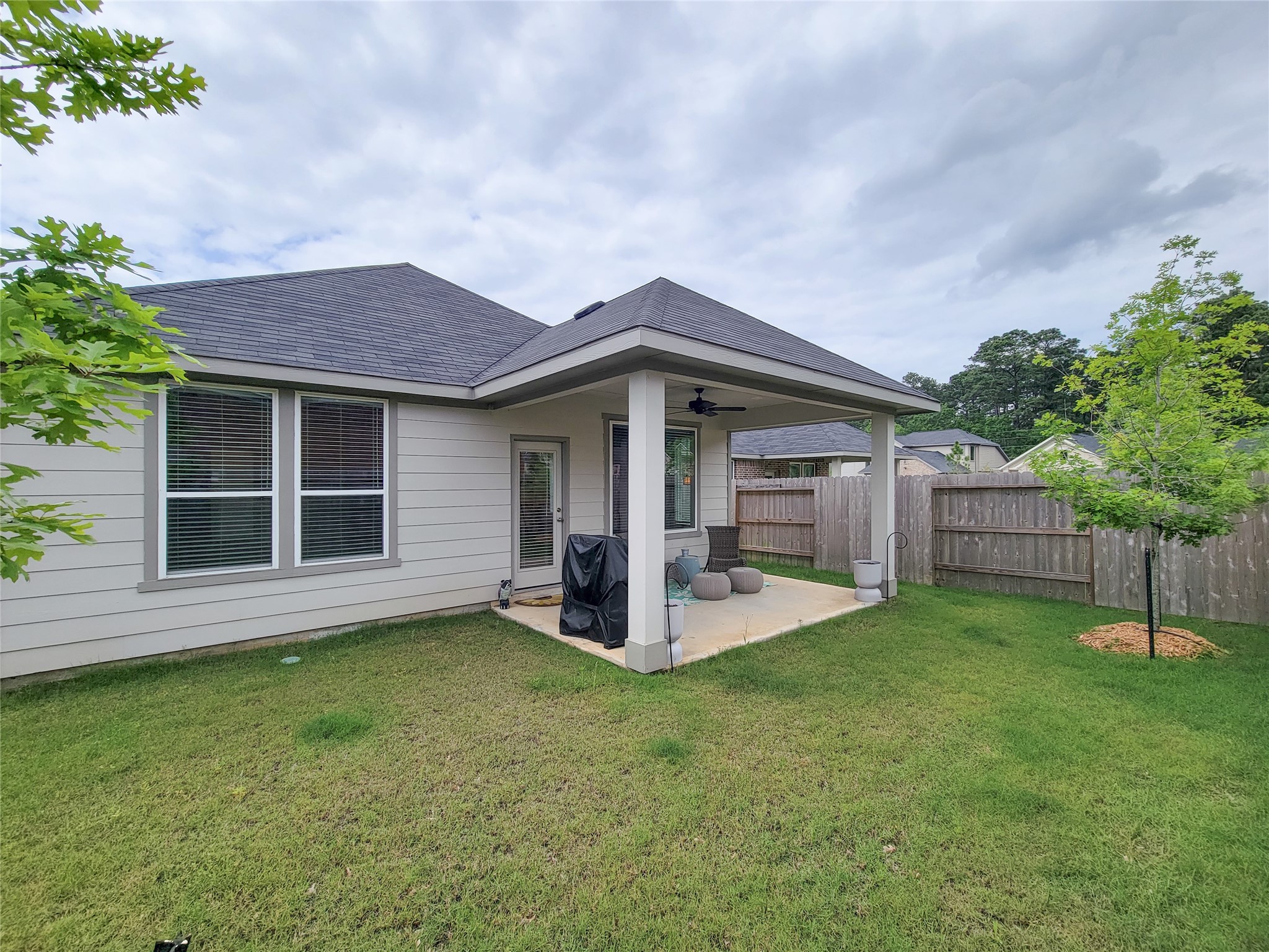 2818 Bluebonnet Ridge Drive Conroe, TX 77304 - Photo 36 of 42 a view of a house with a yard and fence