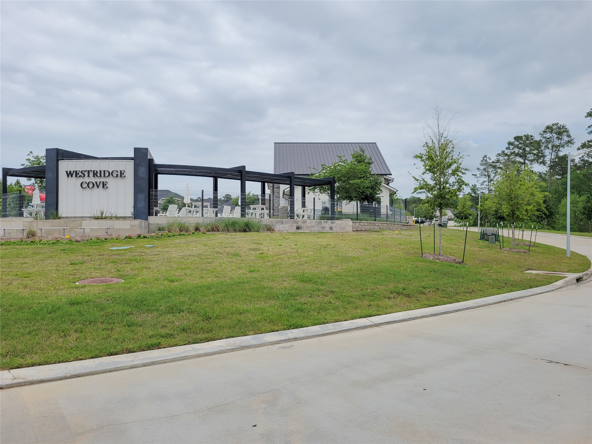 2818 Bluebonnet Ridge Drive Conroe, TX 77304 - Photo 38 of 42 a view of a house with a big yard and a large parking space