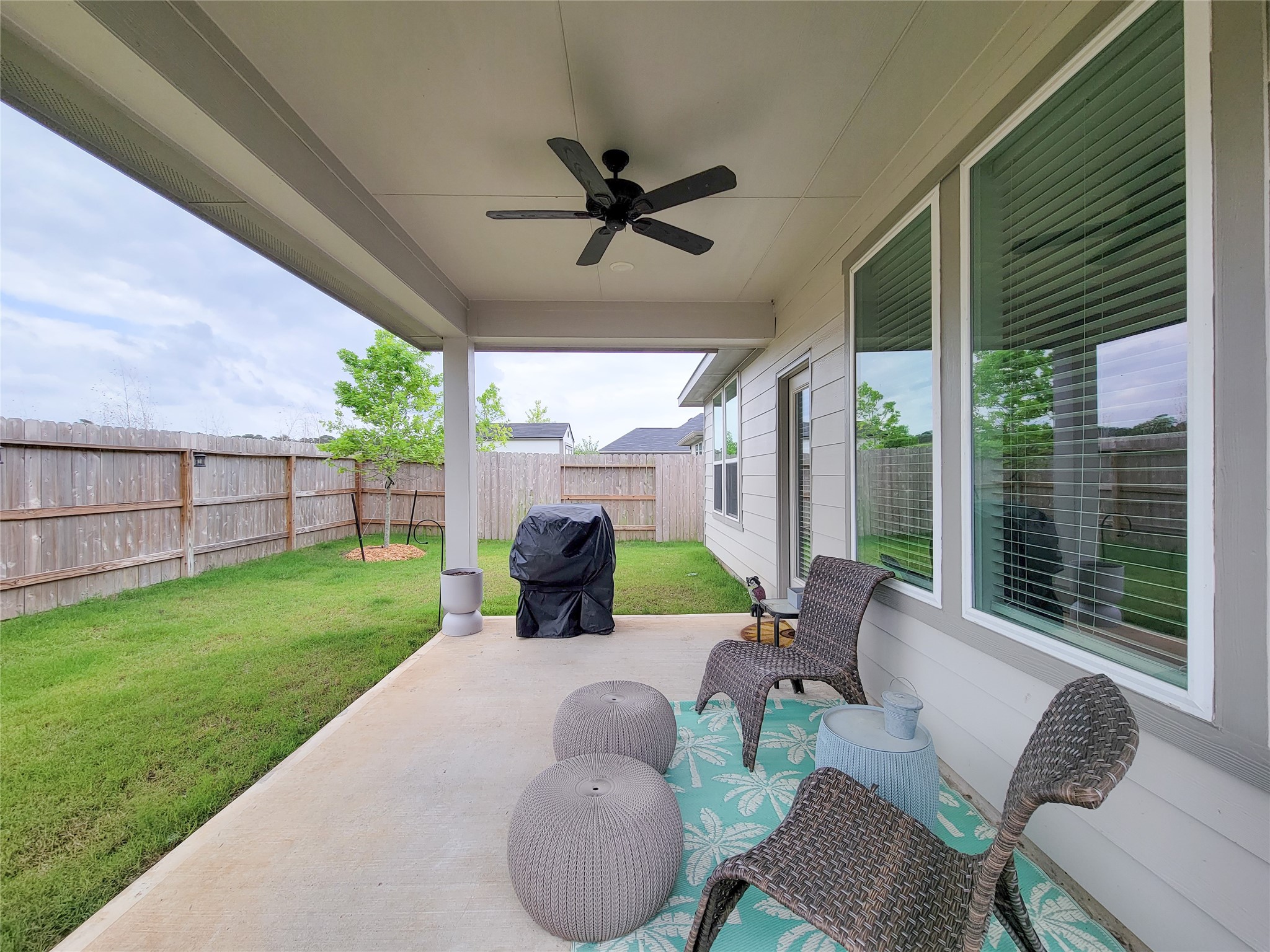 2818 Bluebonnet Ridge Drive Conroe, TX 77304 - Photo 5 of 42 a view of a patio with couches chairs and a table and chairs