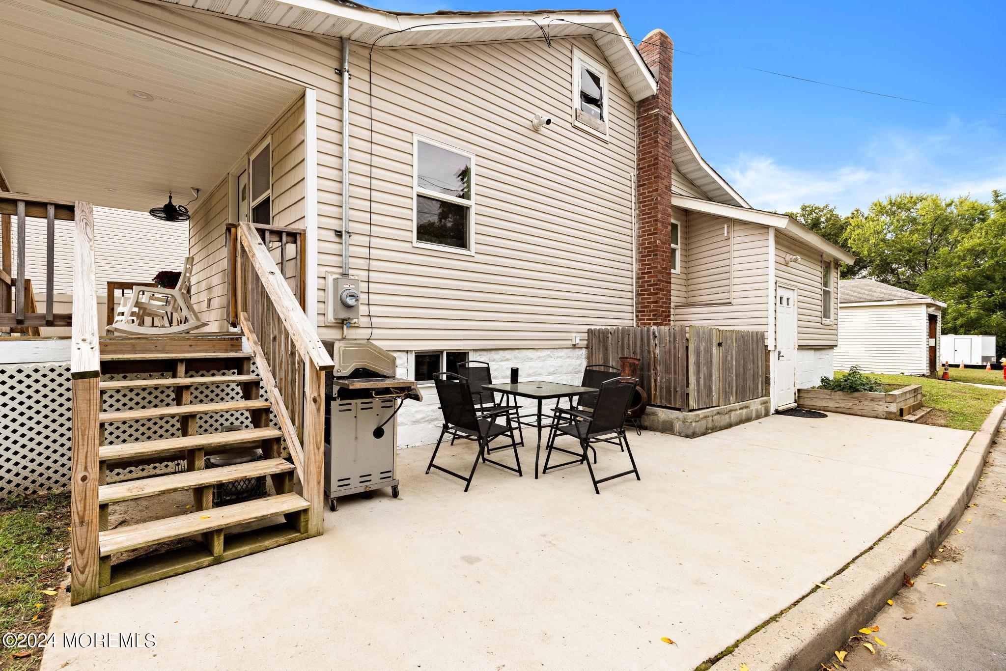 71 Highfield Avenue Matawan, NJ 07747 - Photo 23 of 24 a view of a patio with a table and chairs
