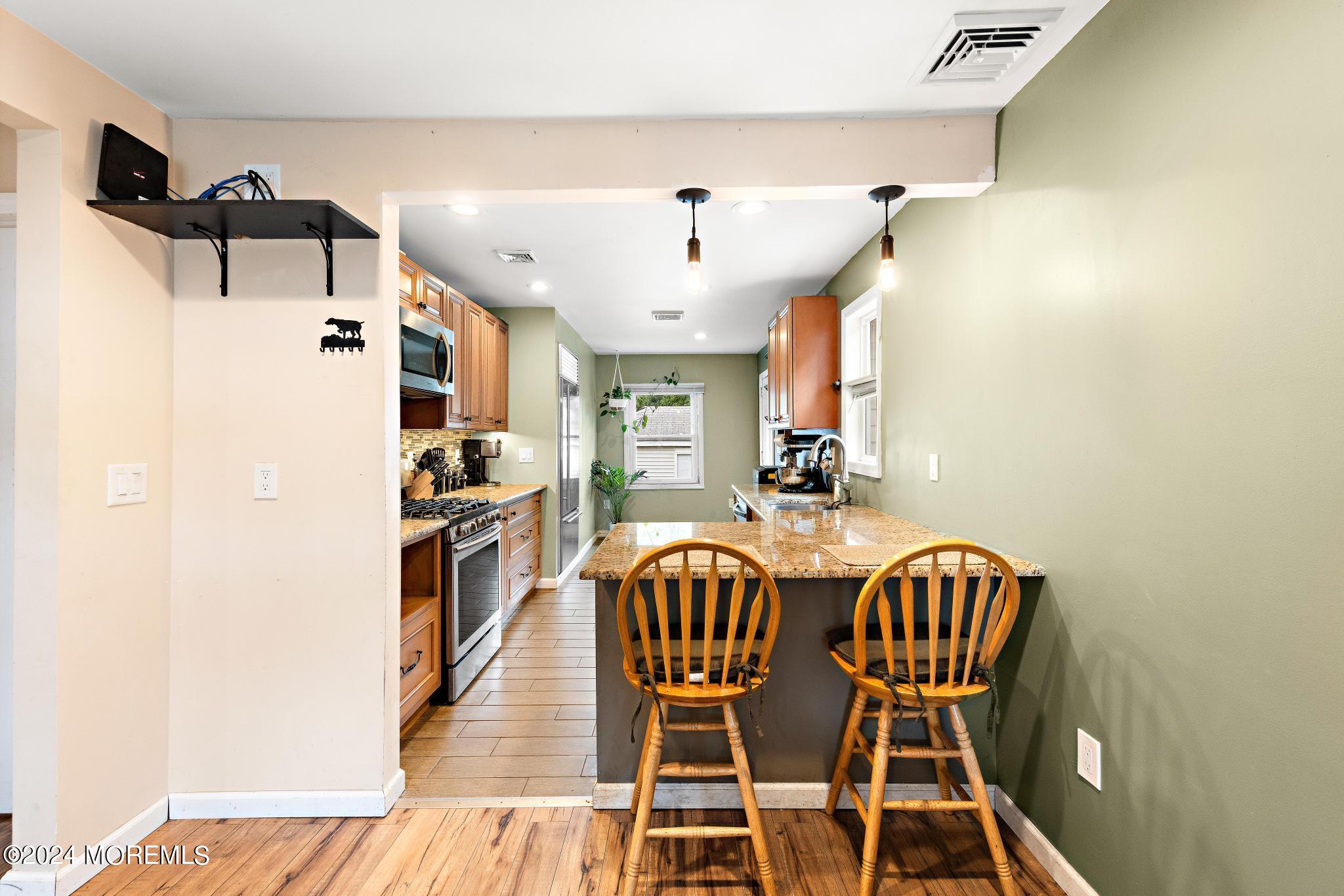 71 Highfield Avenue Matawan, NJ 07747 - Photo 8 of 24 a view of a dining room with furniture and wooden floor
