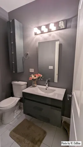 a bathroom with a sink vanity and a mirror