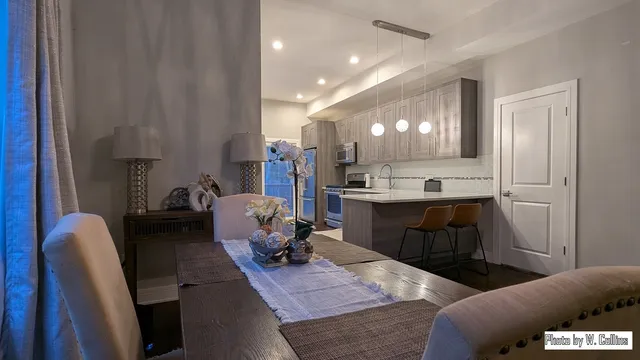 a living room with furniture and kitchen view