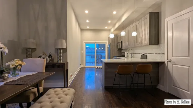 a kitchen with a sink cabinets and wooden floor