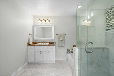 a bathroom with a sink vanity and a mirror