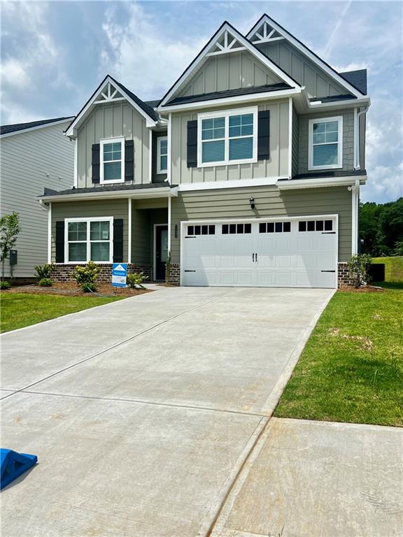 11837 Rizvan Place Covington, GA 30014 - Photo 1 of 1 a front view of a house with a yard