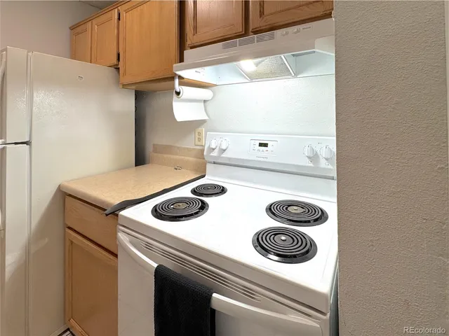a stove top oven sitting inside of a kitchen