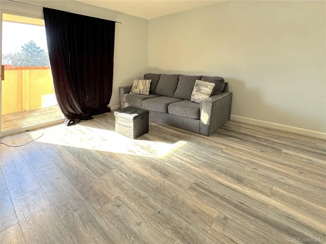 a living room with a couch and a window
