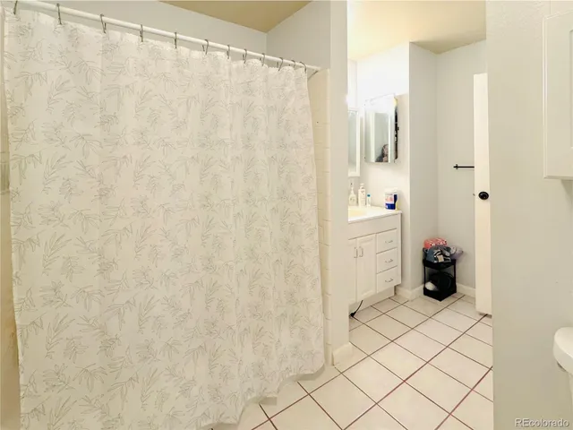 a bathroom with a shower curtain and a sink