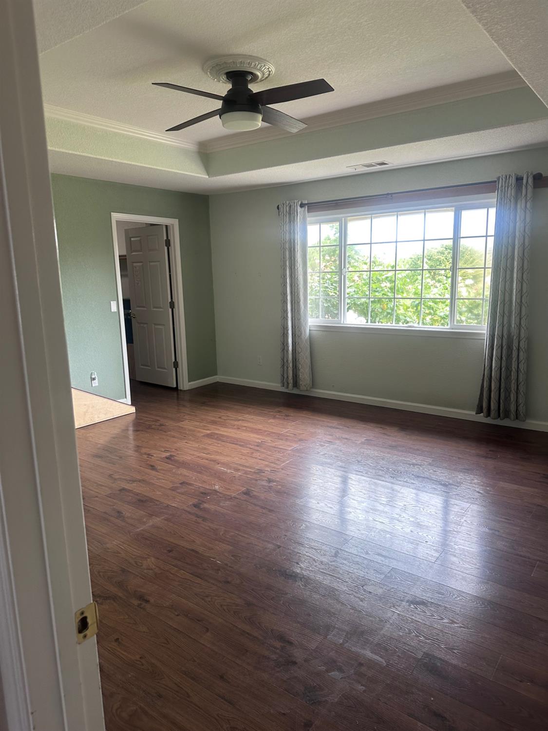 7124 Ospital Road Valley Springs, CA 95252 - Photo 22 of 37 a view of an empty room with a window and wooden floor