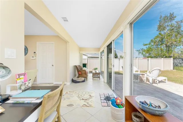 a view of a patio with table and chairs with wooden floor and fence