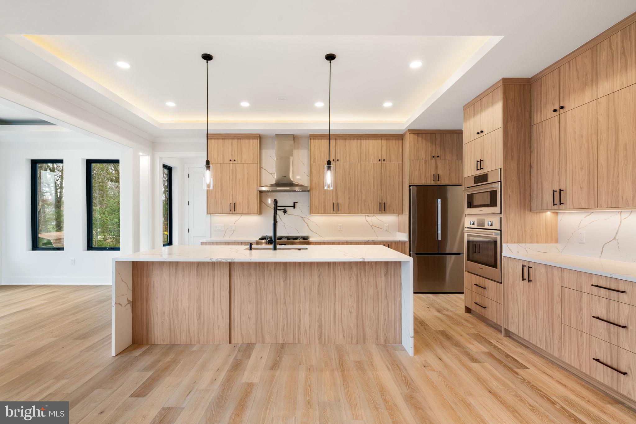 505 Adelman Circle Southwest Vienna, VA 22180 - Photo 12 of 85 a large kitchen with stainless steel appliances kitchen island granite countertop a large counter top a stove a sink and a refrigerator