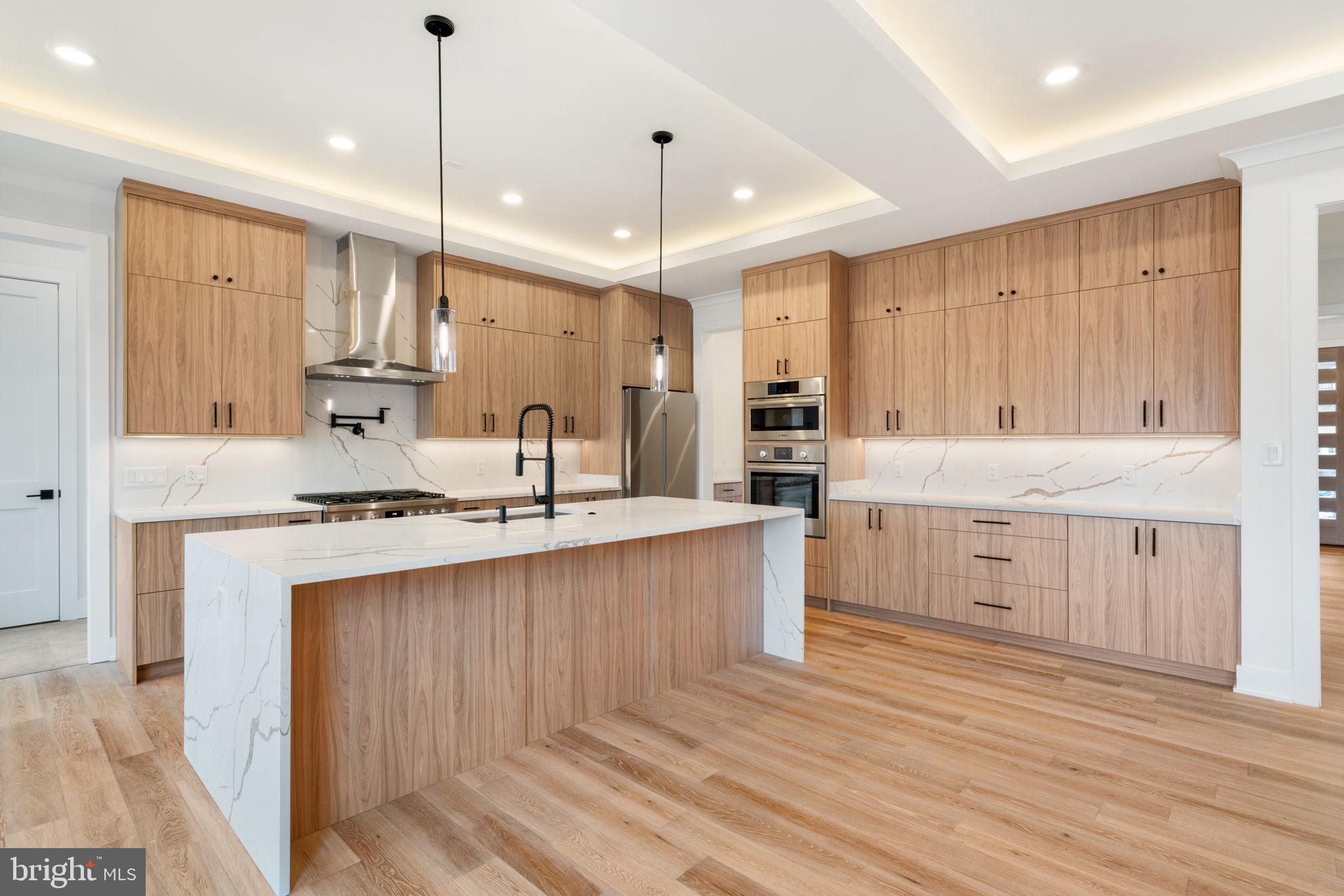 505 Adelman Circle Southwest Vienna, VA 22180 - Photo 13 of 85 a large kitchen with kitchen island a sink stainless steel appliances and cabinets