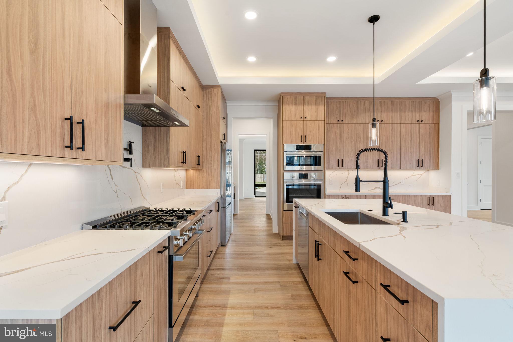 505 Adelman Circle Southwest Vienna, VA 22180 - Photo 15 of 85 a kitchen with stainless steel appliances a sink stove and cabinets