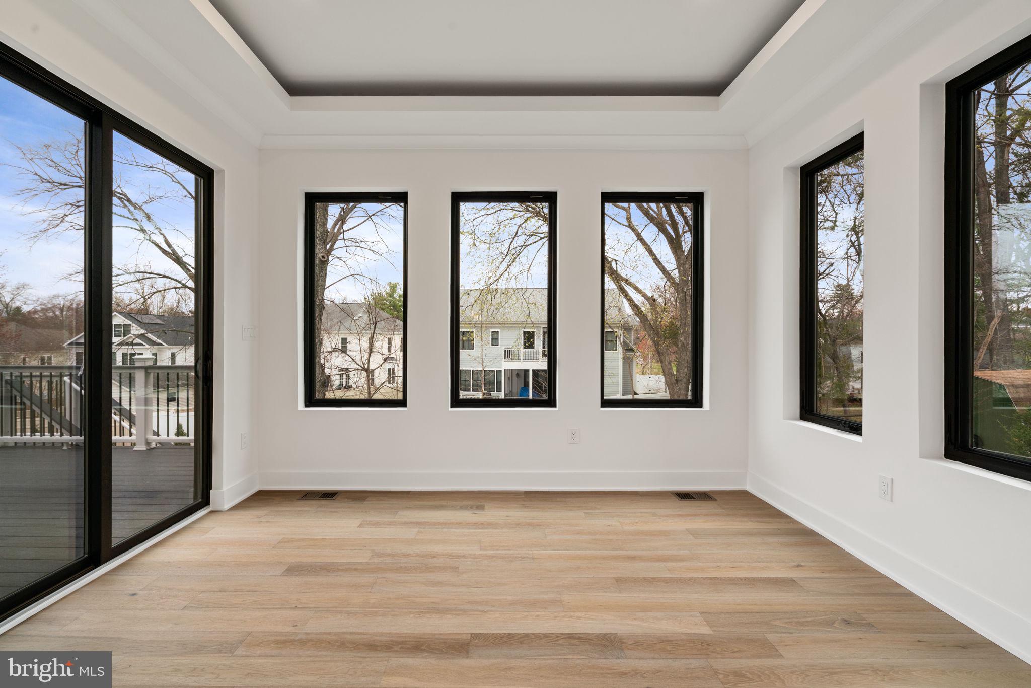 505 Adelman Circle Southwest Vienna, VA 22180 - Photo 23 of 85 a view of an empty room with wooden floor and a window