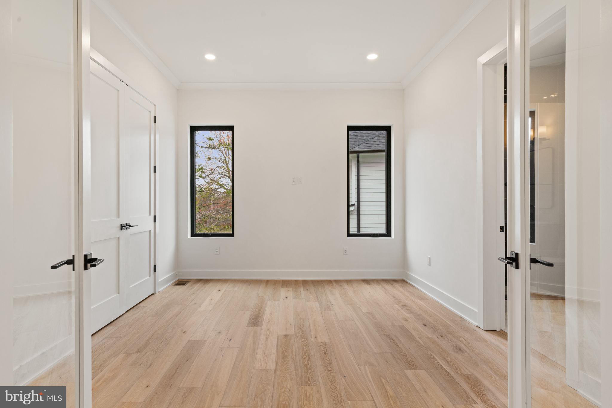 505 Adelman Circle Southwest Vienna, VA 22180 - Photo 25 of 85 an empty room with wooden floor and a ceiling fan