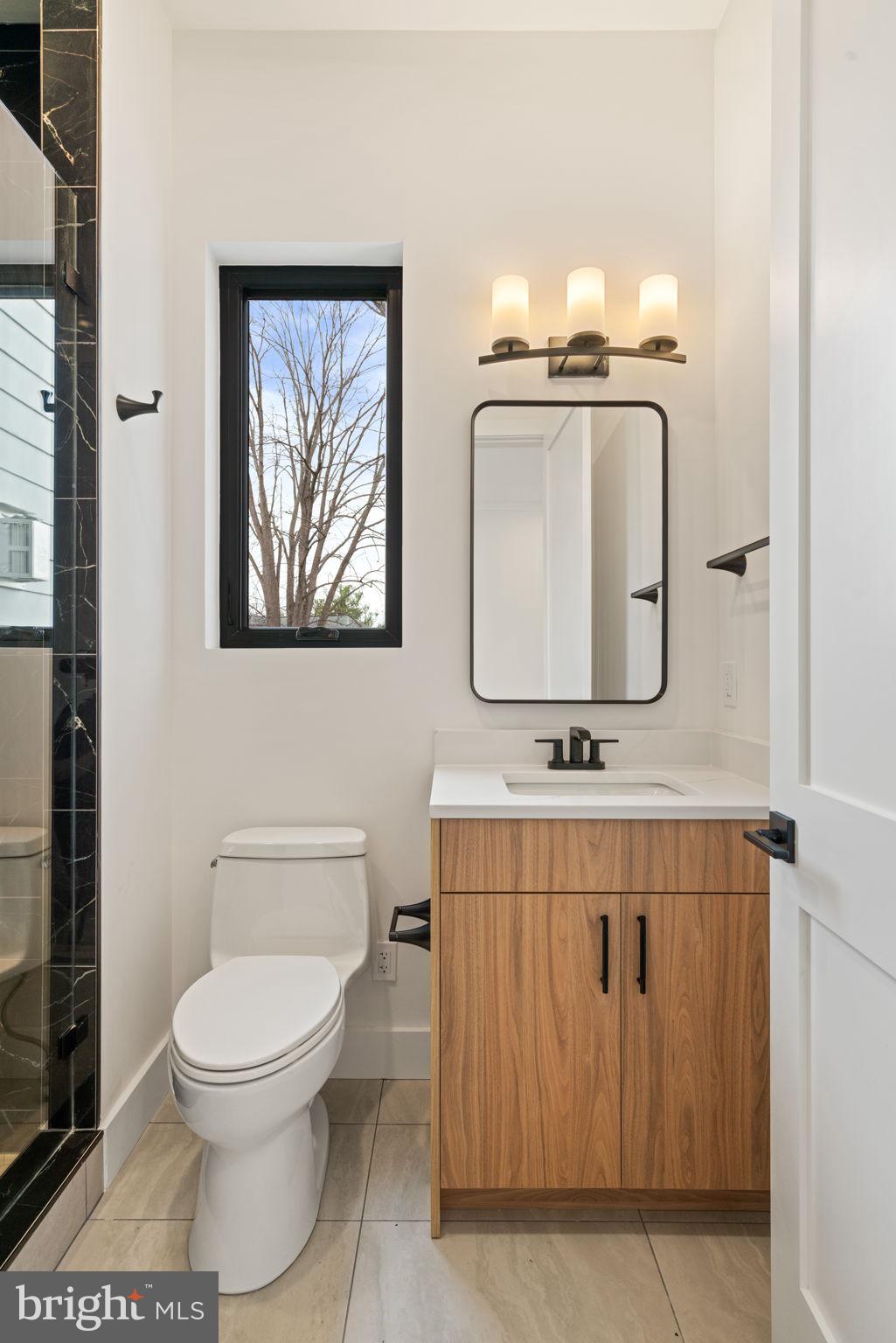 505 Adelman Circle Southwest Vienna, VA 22180 - Photo 28 of 85 a bathroom with a toilet a sink and mirror