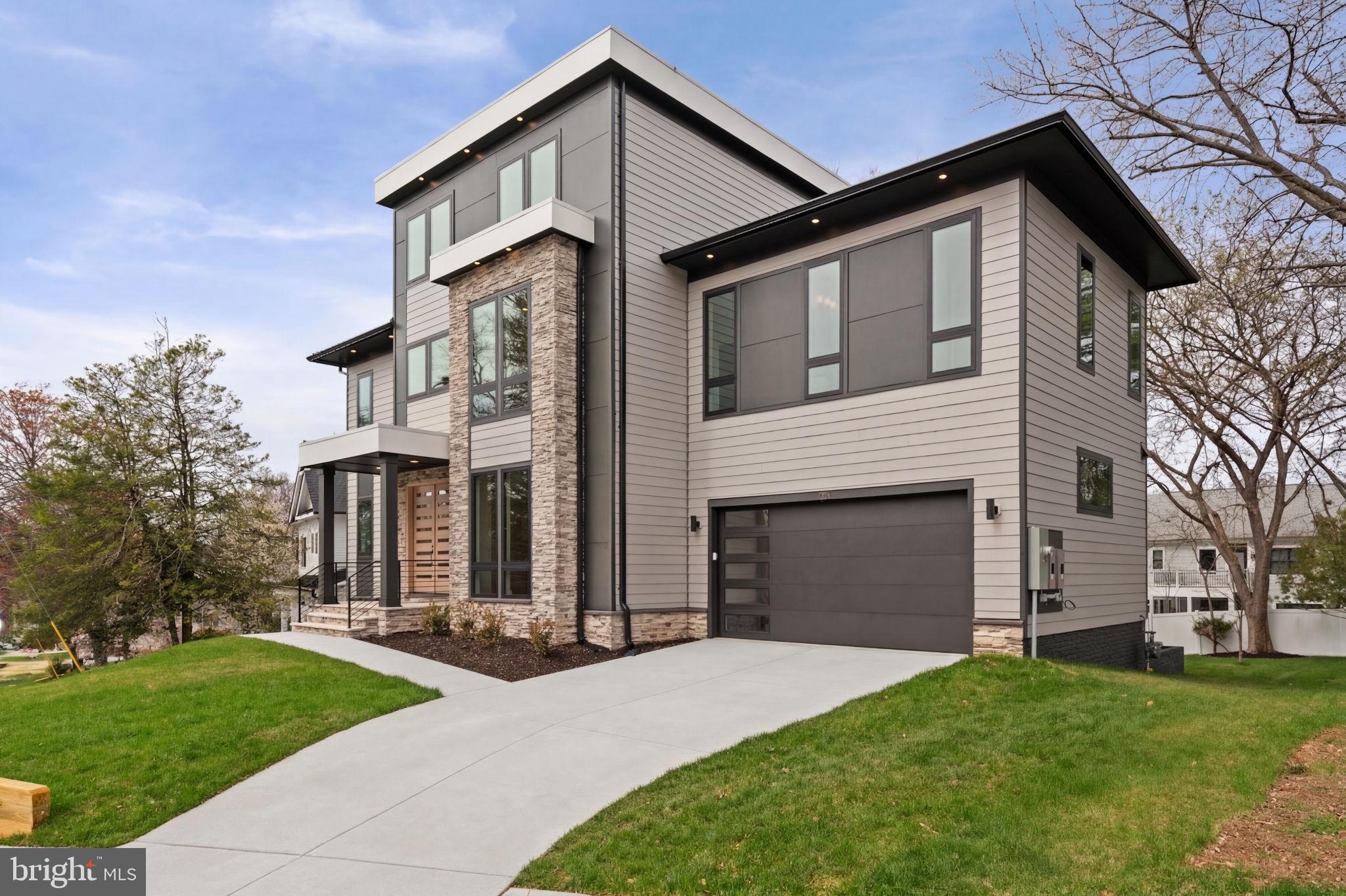 505 Adelman Circle Southwest Vienna, VA 22180 - Photo 3 of 85 a front view of a house with a yard and garage