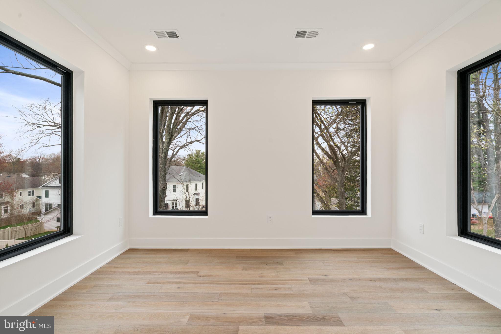 505 Adelman Circle Southwest Vienna, VA 22180 - Photo 35 of 85 a view of an empty room with window and wooden floor