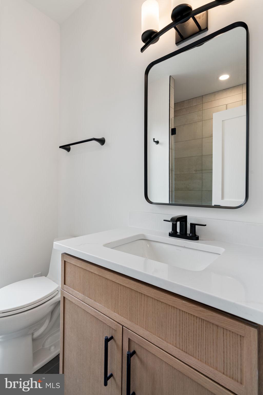 505 Adelman Circle Southwest Vienna, VA 22180 - Photo 46 of 85 a bathroom with a toilet sink and mirror