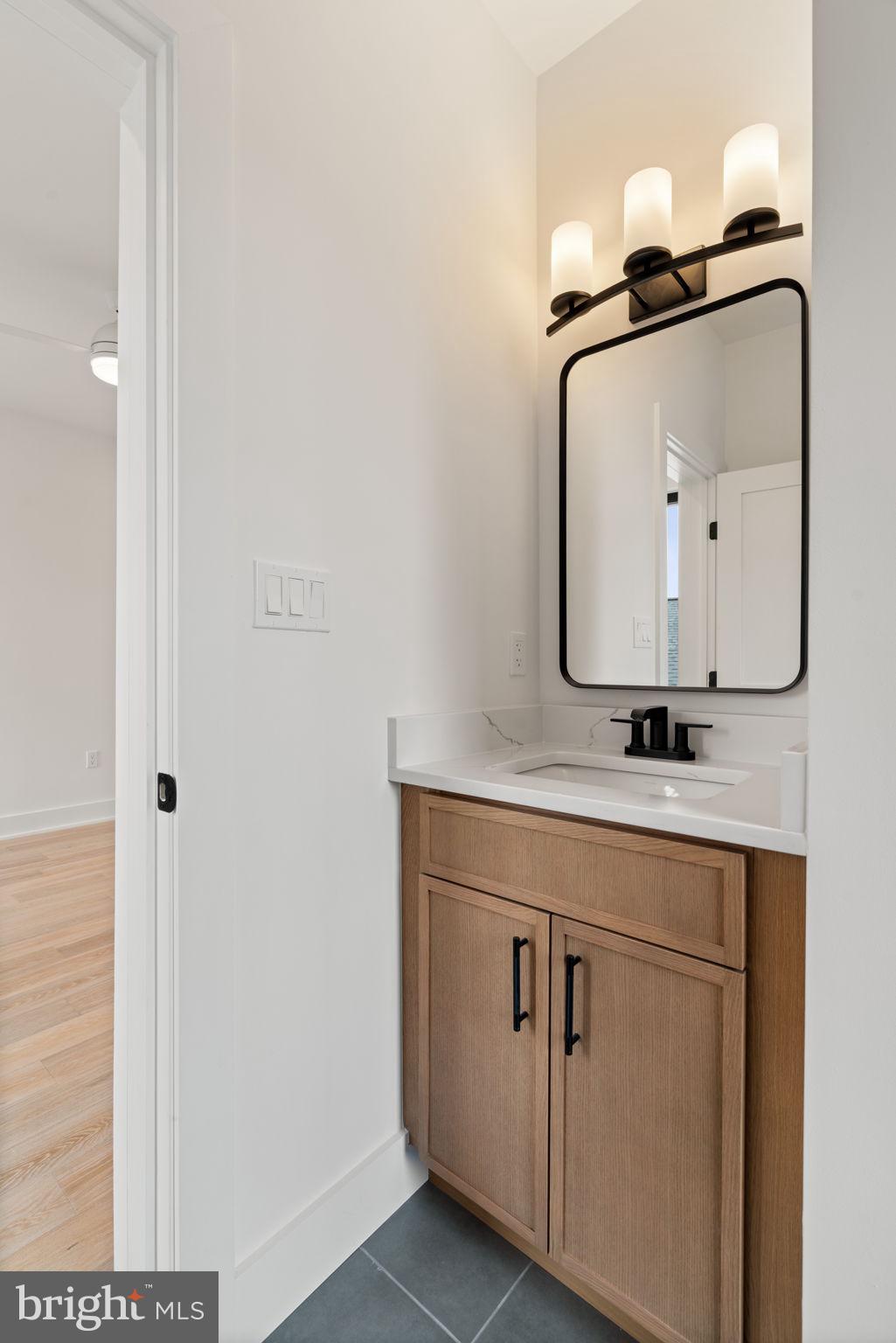 505 Adelman Circle Southwest Vienna, VA 22180 - Photo 50 of 85 a bathroom with a sink vanity and a mirror