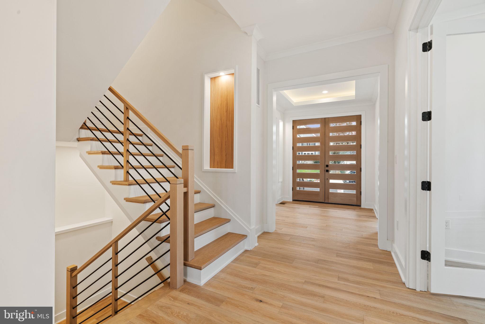 505 Adelman Circle Southwest Vienna, VA 22180 - Photo 5 of 85 a view of a hallway with wooden floor and staircase
