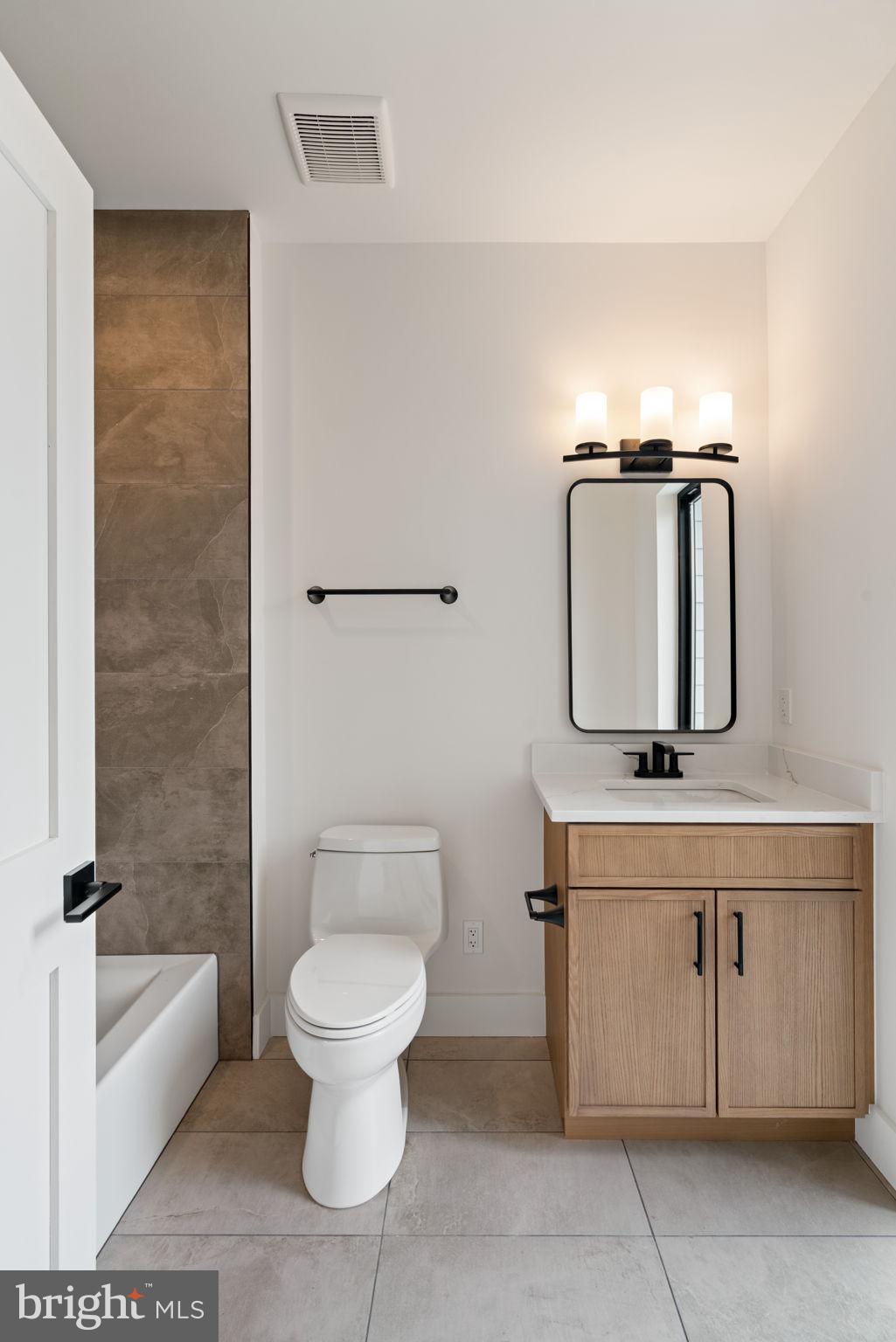 505 Adelman Circle Southwest Vienna, VA 22180 - Photo 54 of 85 a bathroom with a toilet a sink and mirror