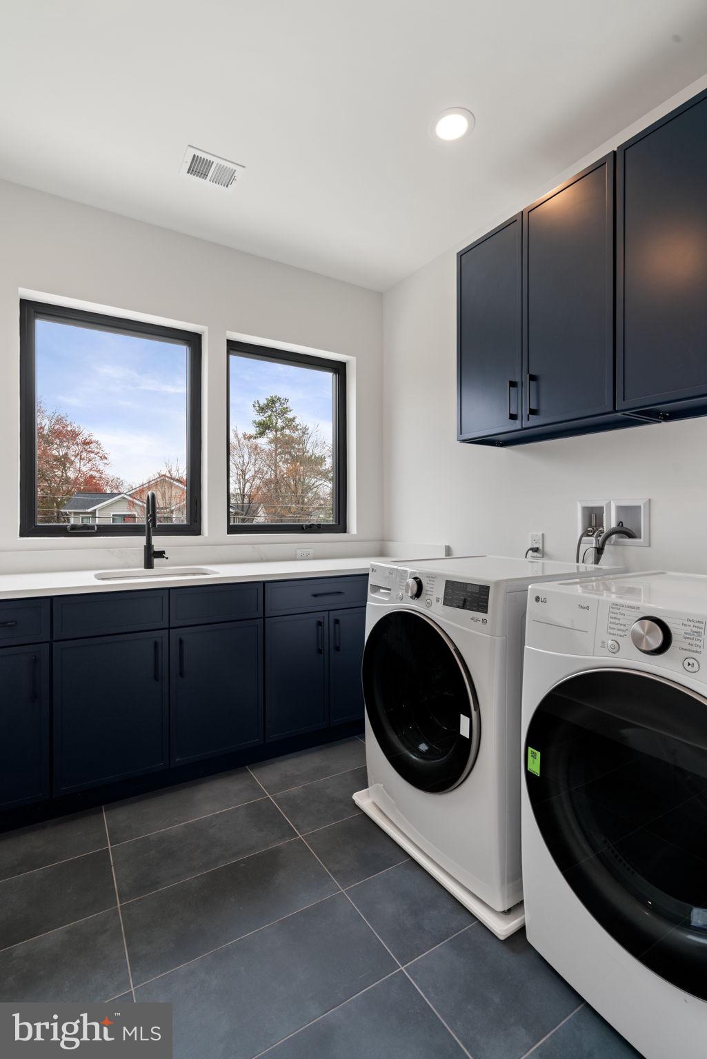 505 Adelman Circle Southwest Vienna, VA 22180 - Photo 57 of 85 a utility room with sink dryer and washer
