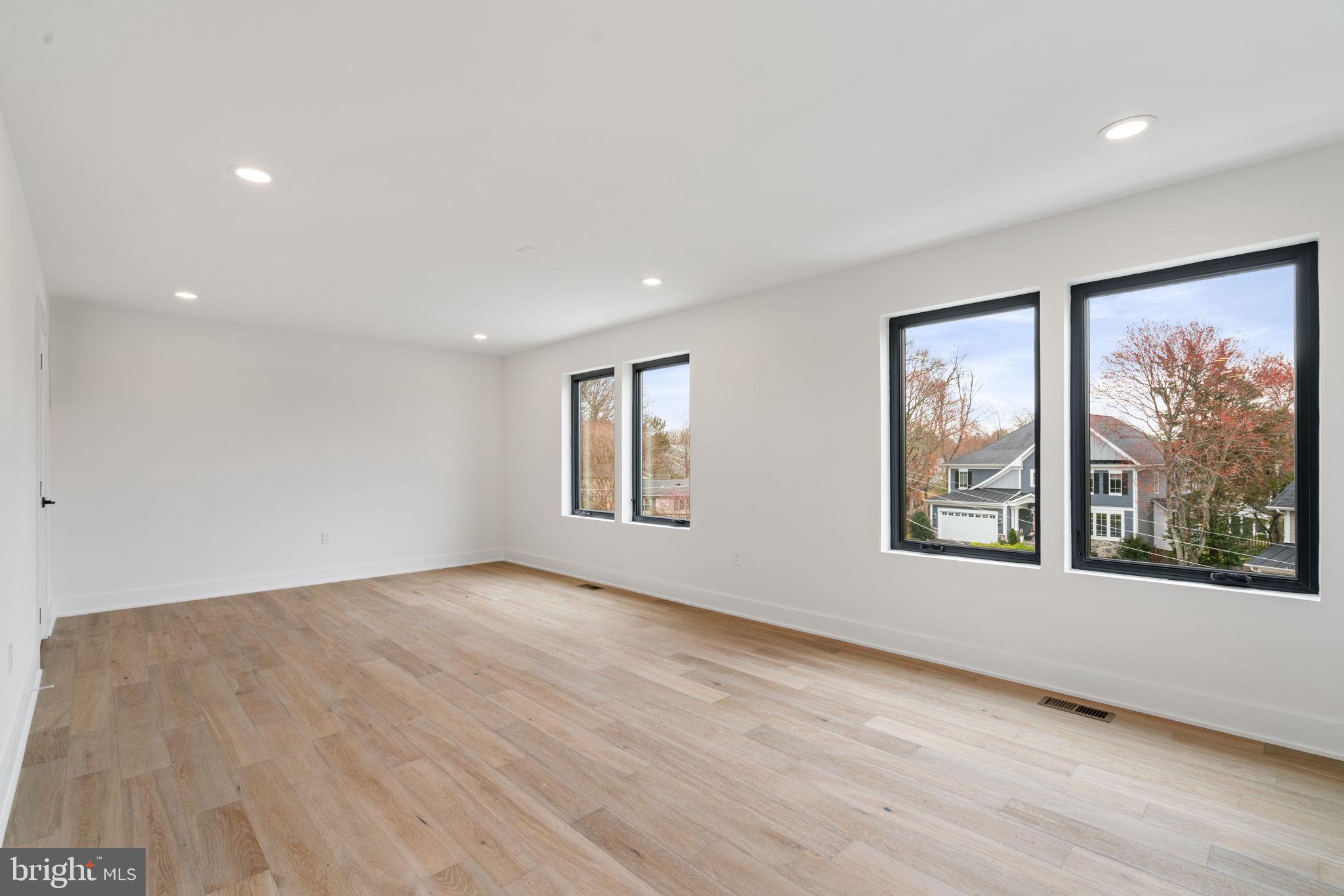 505 Adelman Circle Southwest Vienna, VA 22180 - Photo 61 of 85 a view of an empty room with a window and wooden floor