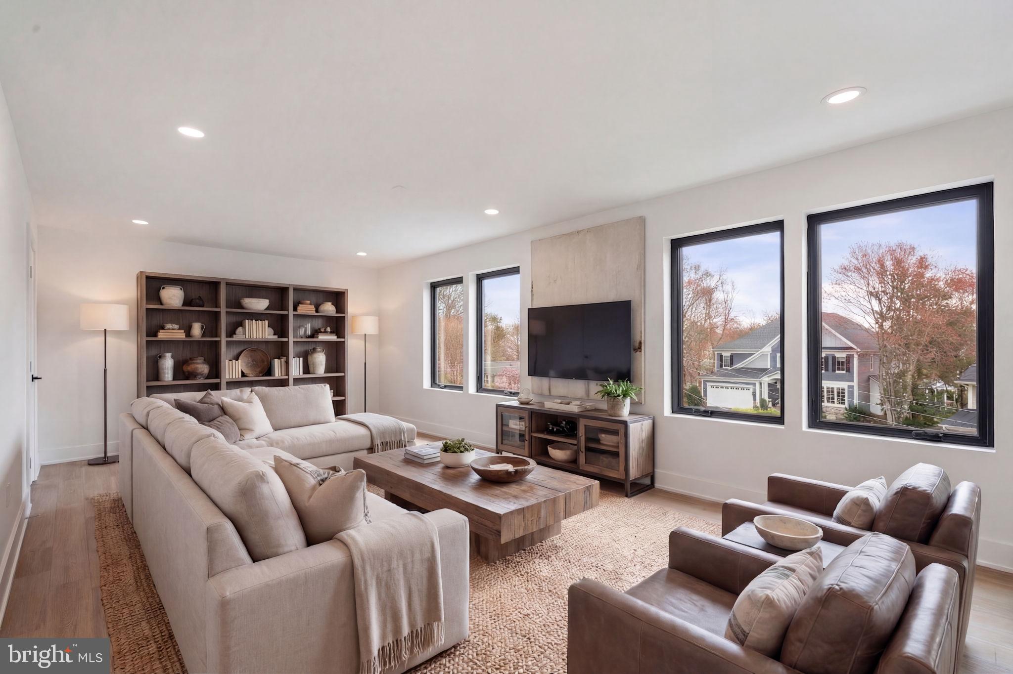 505 Adelman Circle Southwest Vienna, VA 22180 - Photo 62 of 85 a living room with furniture a large window and a flat screen tv
