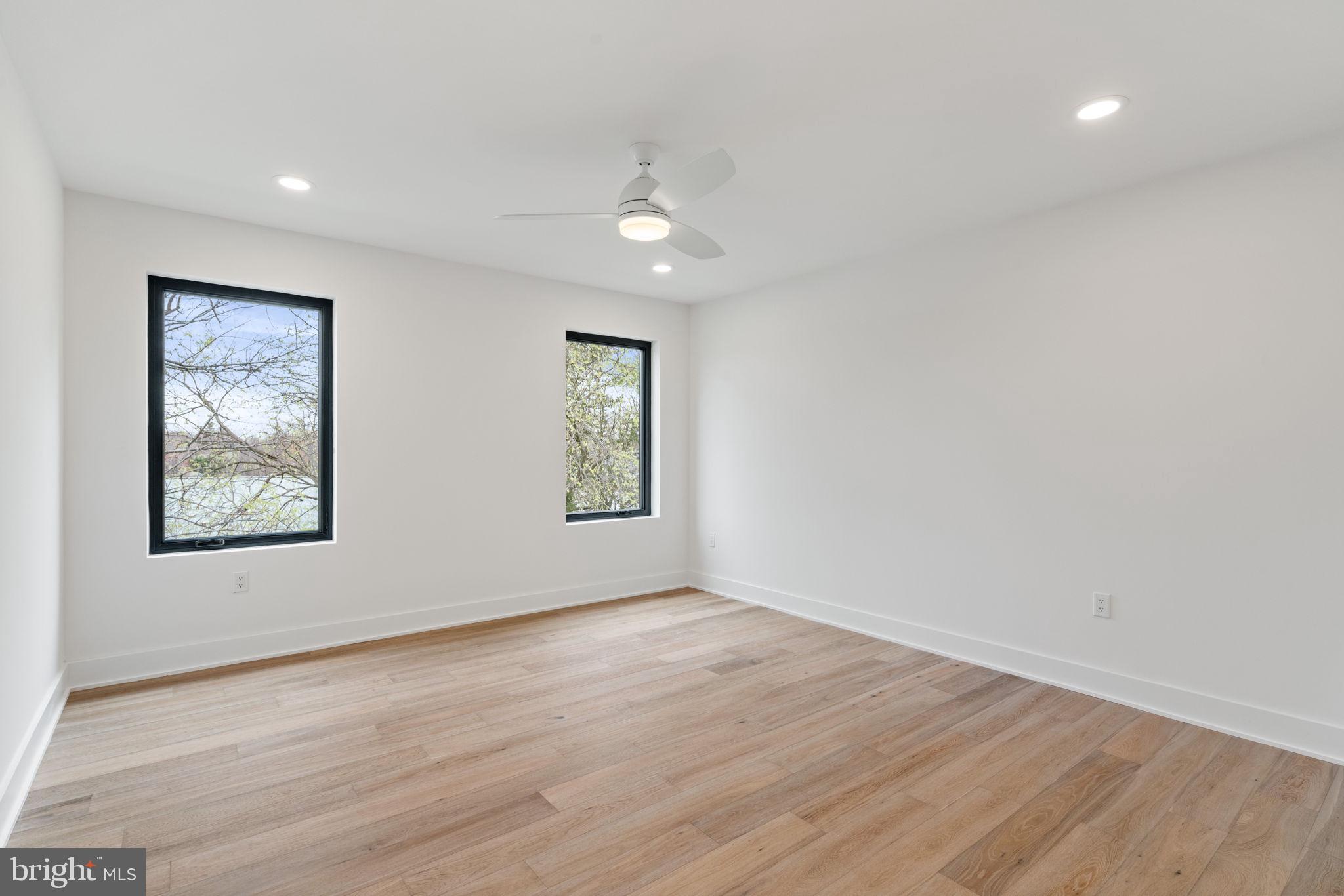 505 Adelman Circle Southwest Vienna, VA 22180 - Photo 65 of 85 a view of an empty room with wooden floor and a window