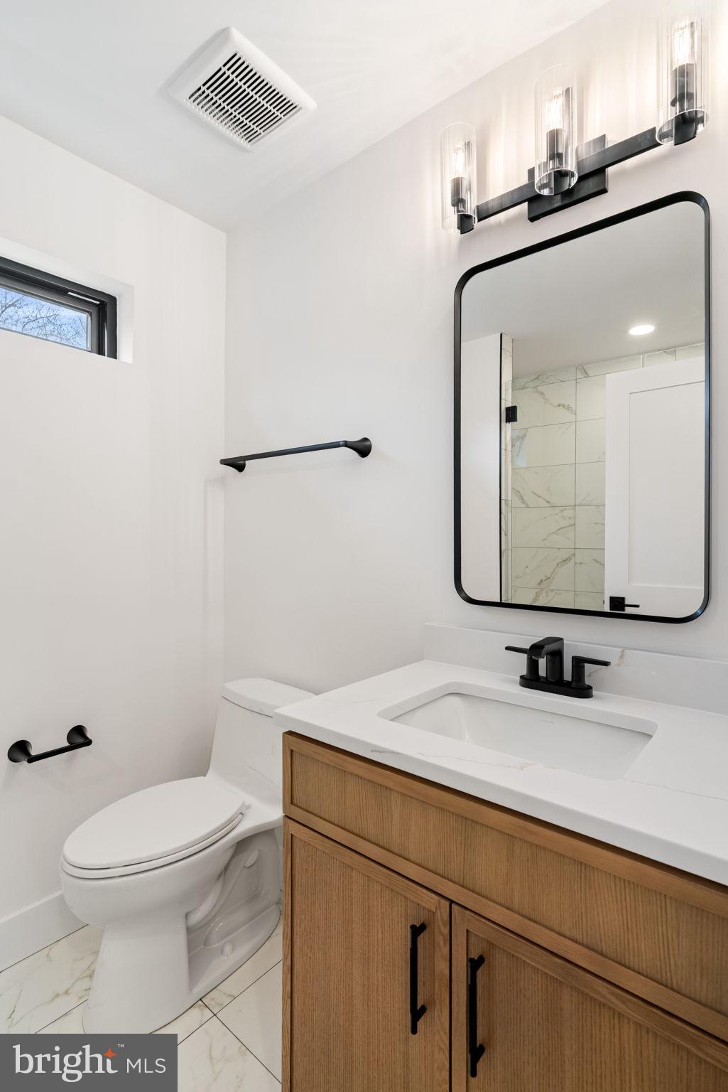 505 Adelman Circle Southwest Vienna, VA 22180 - Photo 66 of 85 a bathroom with a toilet a sink and mirror