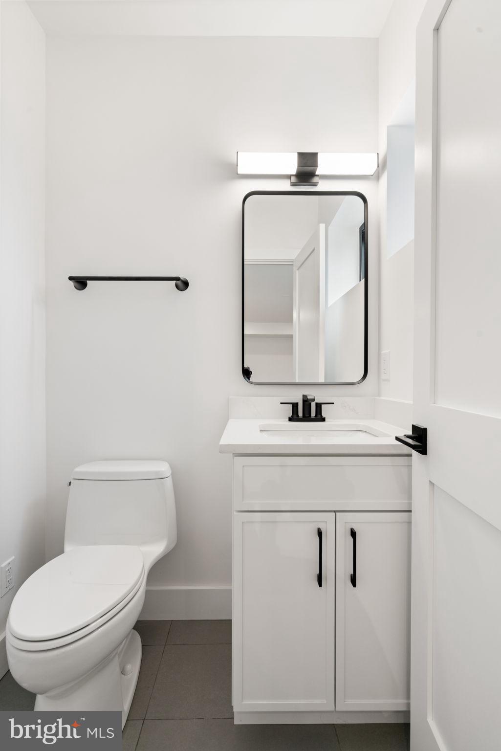 505 Adelman Circle Southwest Vienna, VA 22180 - Photo 73 of 85 a bathroom with a toilet sink and mirror
