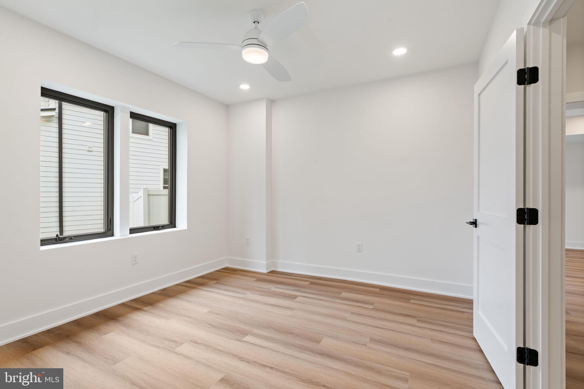 505 Adelman Circle Southwest Vienna, VA 22180 - Photo 76 of 85 a view of an empty room with wooden floor and a window