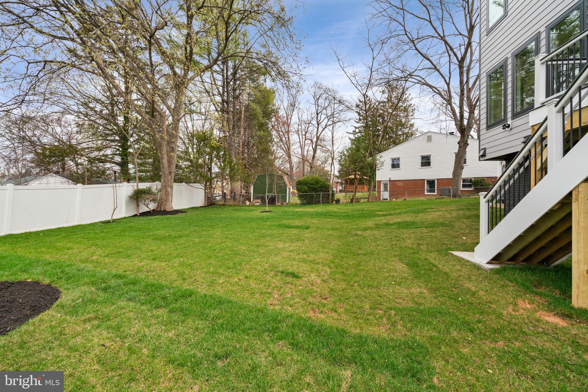 505 Adelman Circle Southwest Vienna, VA 22180 - Photo 84 of 85 a view of a house with a big yard and large trees