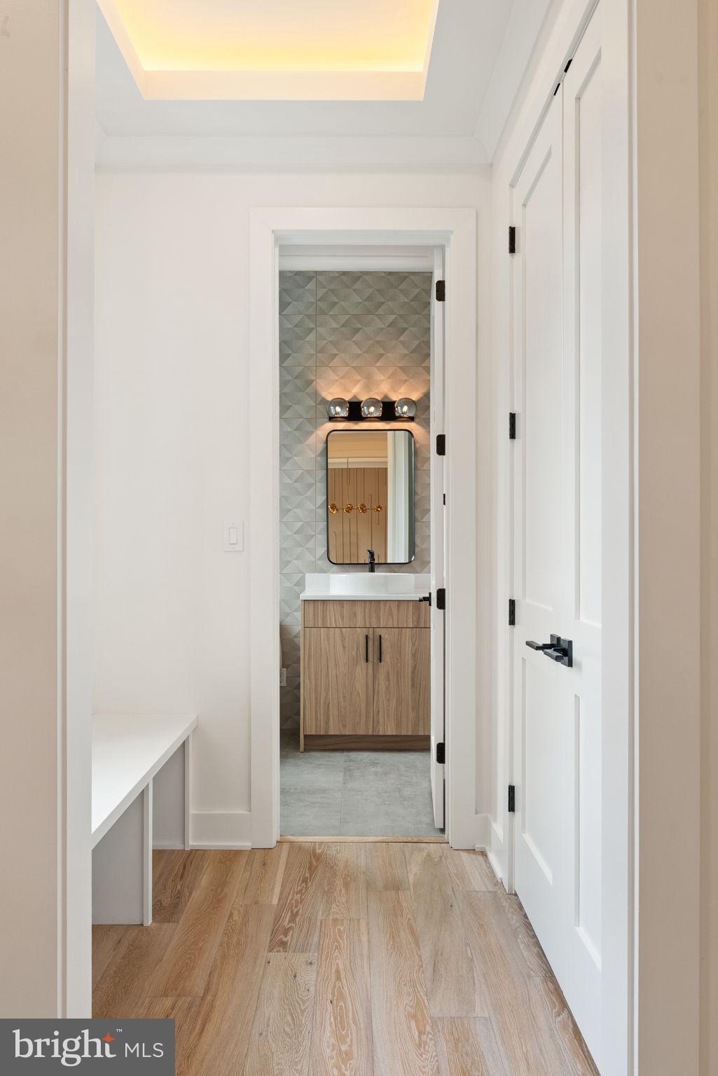 505 Adelman Circle Southwest Vienna, VA 22180 - Photo 10 of 85 a view of a hallway with wooden floor and a cabinet