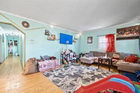 a kitchen with kitchen island a sink dishwasher a stove and a refrigerator with wooden floor