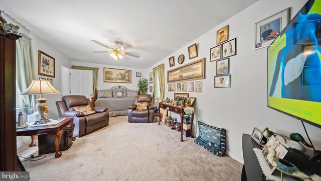 a living room with furniture chess board and a window