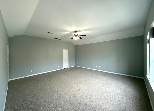 a spacious bathroom with a tub sink and mirror