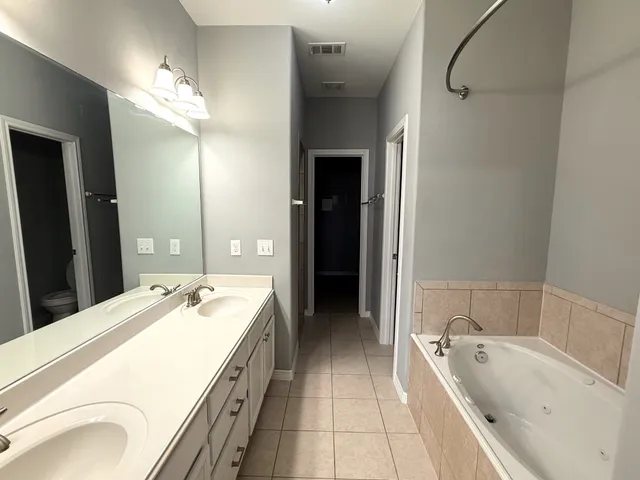 a bathroom with a double vanity sink and a mirror