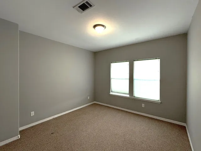 an empty room with a empty space and windows