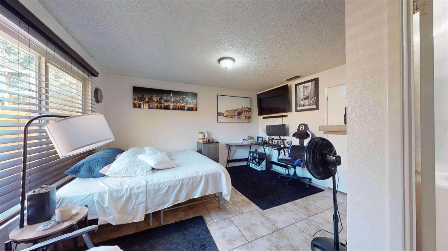 4005 Honey Creek Road Modesto, CA 95356 - Photo 16 of 25 a bedroom with a bed a chair and a large window