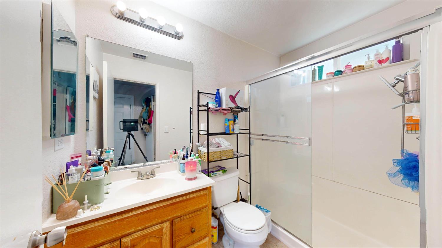 4005 Honey Creek Road Modesto, CA 95356 - Photo 17 of 25 a bathroom with a sink vanity mirror and toilet