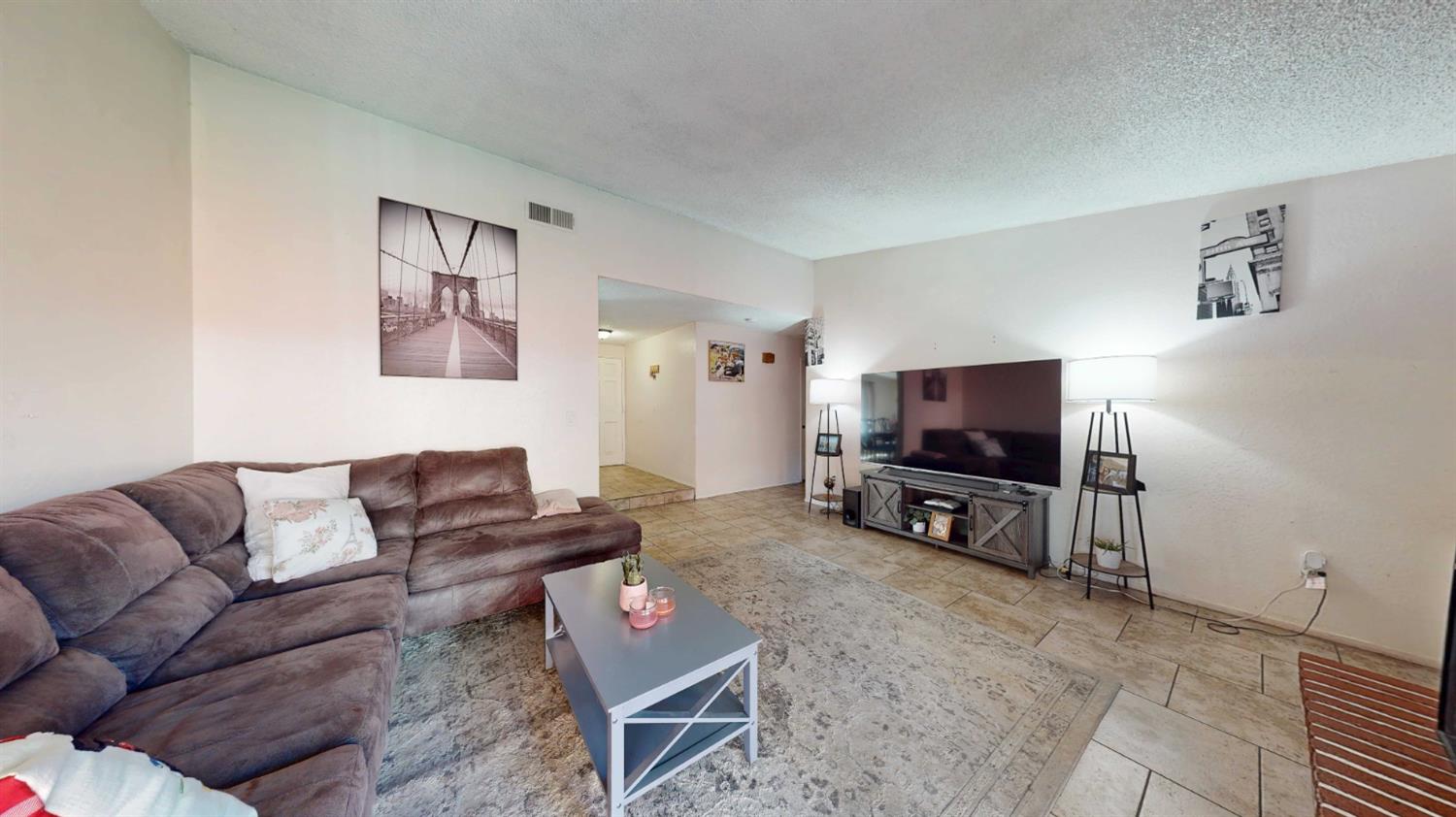 4005 Honey Creek Road Modesto, CA 95356 - Photo 19 of 25 a living room with furniture and a flat screen tv