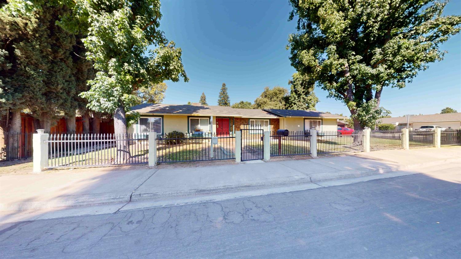 4005 Honey Creek Road Modesto, CA 95356 - Photo 2 of 25 a view of a white house with a large tree and a yard