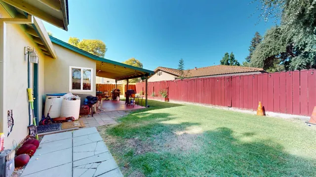 a view of a house with backyard swimming pool and sitting area